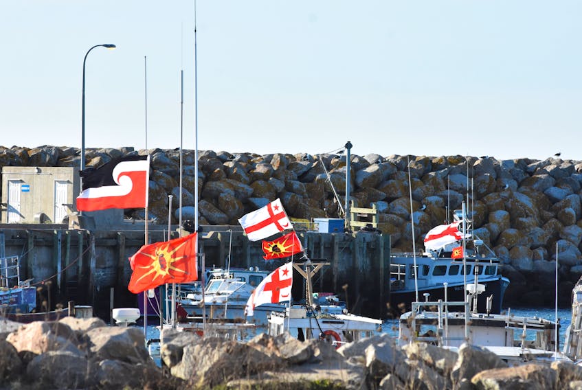 Flags flap in the wind from Sipekne’katik First Nation boats tied up at the Saulnierville wharf. TINA COMEAU PHOTO