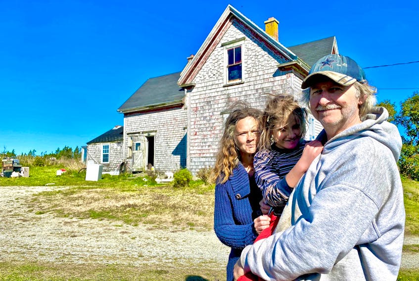 Heather and Anthony Nickerson with daughter Kaleigh in front of their Yarmouth County home.