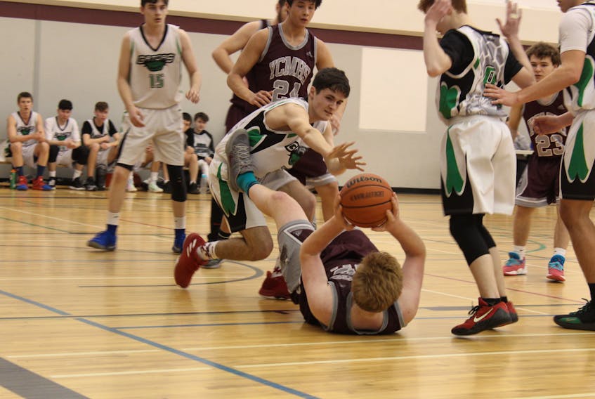 Noah Wilcox is on his back but has the ball during a Feb. 16 high school boys basketball game in Yarmouth. The host Vikings defeated visiting Central Kings 99-68. ERIC BOURQUE