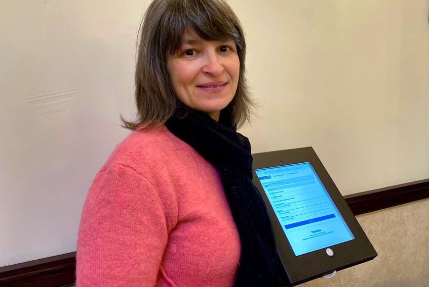 Municipality of Yarmouth tax clerk Linda Power, beside the new iPad kiosk in the administrative building that residents can now use for credit card payments for services.