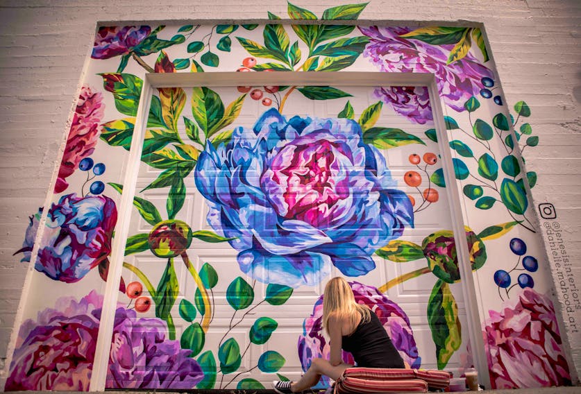 Danielle Mahood at work on the mural commissioned in 2019 by Jenesis Interiors on Water Street. 
Keane Wheeler Photo