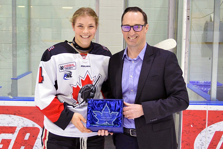 Meadow Carman – a Digby County native who has spent the past two years attending high school in B.C. and playing in the Canadian Sport School Hockey League – receives the league’s female humanitarian of the year award from CSSHL commissioner Kevin Goodwin.
