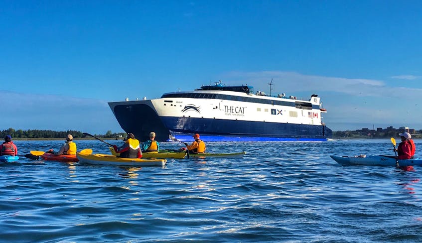 A flotilla of kayakers sees the Cat off from Yarmouth at the start of its 2017 season.