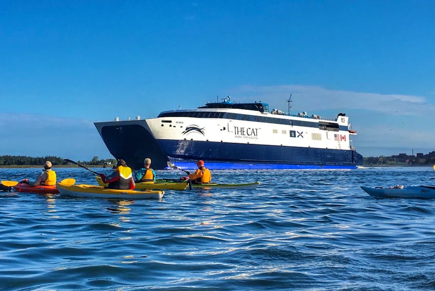 A flotilla of kayakers sees the Cat off from Yarmouth at the start of its 2017 season.
