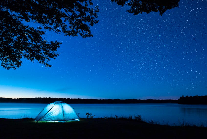 This photograph was taken at Ellenwood Lake Provincial Park and featuring a tent glowing in contrast against the star filled skies of Yarmouth & Acadian Shores graces the cover of the 2019 French Doers and Dreamers tourism guide in Nova Scotia. 
JAMES INGRAM PHOTO