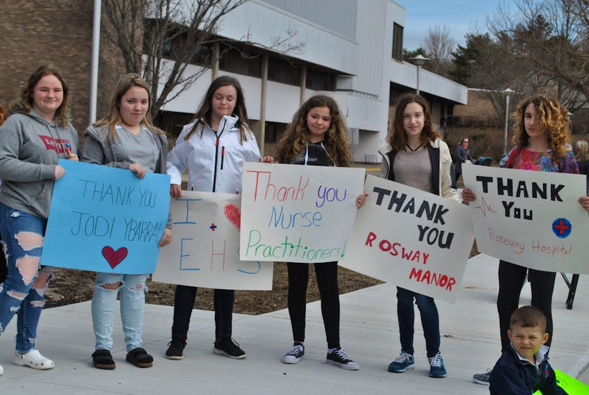 Shelburne high school students (from left) Gabe Hemeon, Destiny Harris, Brooke Bower, Falan Clarey Kailey Wolkins and Josie Stewart hold the posters they made thanking various sectors of health-care providers at the support rally on March 31 in Sandy Point.