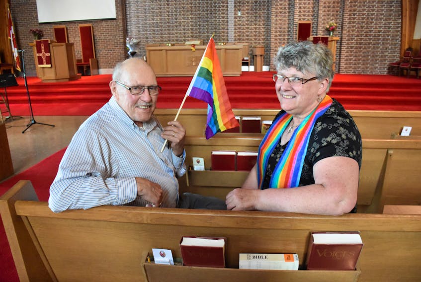 Jack Murphy and Reverend Sharon Lohnes sit inside Beacon United Church in Yarmouth. The church is in the process of becoming an affirming church that officially welcomes members of the LGTBQ community. TINA COMEAU PHOTO