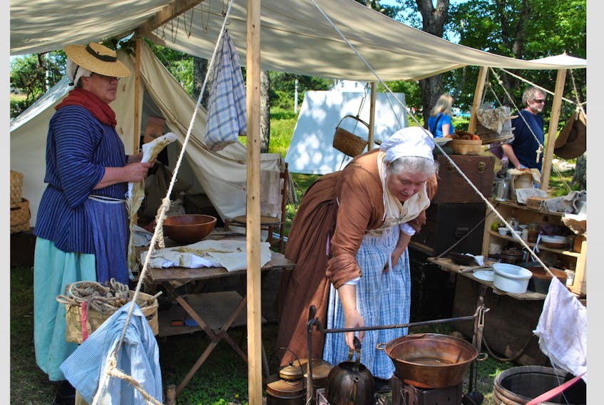 Atlantic Living Heritage Association reenactor Jenny Milligan from Bear River puts a kettle on the fire, while re-enactor Valerie Fowler watches in the background, during the New England Planters encampment in Barrington in 2017. A clothing expert, Milligan will be giving a presentation at the Old Meeting House during this year’s Planter’s Encampment on Aug. 4 starting at 7 p.m.
