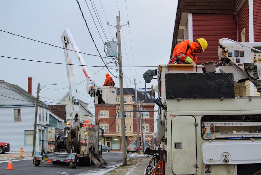 NS Power linesmen Dillon Keddy (foreground) and Jeff Gates (background) work at repairing lines on Dec. 27 on Cliff Street after a strong wind storm on Christmas day. NS Power says Nova Scotians should be prepared to be without power for days due to a severe storm that will hit the province Jan. 4 and 5. CARLA ALLEN