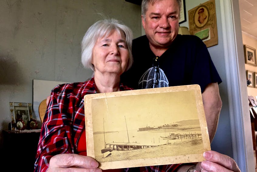 Doris Watkins and Mike Cunningham with a photo of the Yarmouth Bar in 1885.