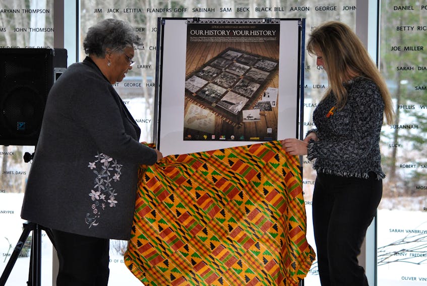 Dr. Elizabeth Cromwell and Shelburne Municipal Warden Penney Smith unveil the poster for African Heritage Month at the Municipal Proclamation Launch on Feb. 4 at the Black Loyalist Heritage Centre in Birchtown. KATHY JOHNSON PHOTO