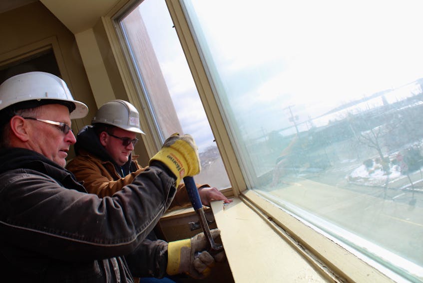 Garian Construction employees Stan Ellis and Logan d’Entremont work at ripping off a sill at the Rodd Colony Harbor Inn. All windows in the facility are being replaced, along with many other renovations this year.