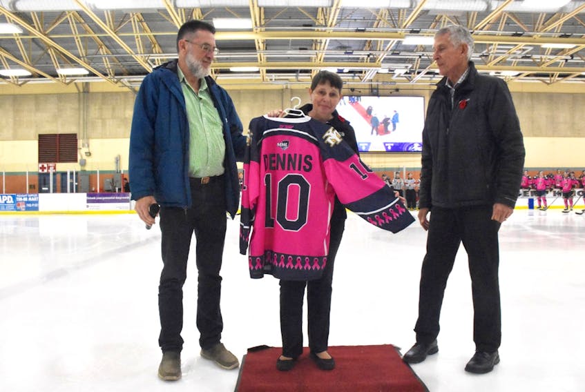 Yarmouth Mariners owner Mitch Bonnar presented the pink #10 jersey to Sandy Dennis, as her husband Ken looked on. TINA COMEAU PHOTO