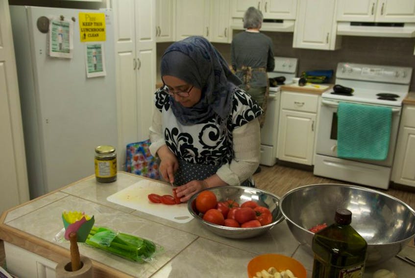 Rima Kenaan prepares ingredients for the cooking demonstration.