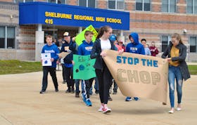 Students from Shelburne Regional High School and some community members participating in a May 3 walk aimed at drawing attention to clearcutting and climate change issues. KATHY JOHNSON PHOTO