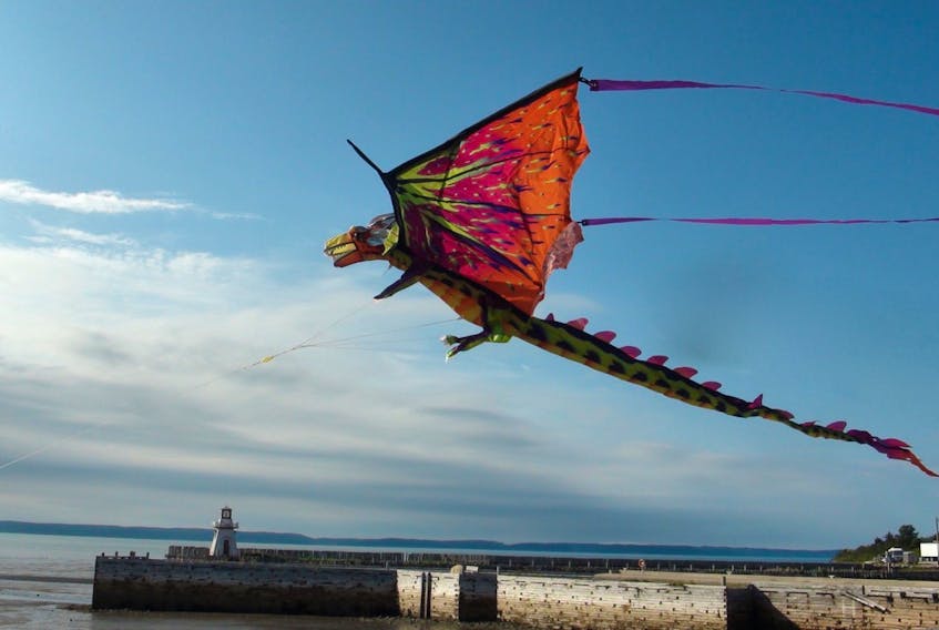 Kites fly high at low tide at the beach in Belliveau Cove.
