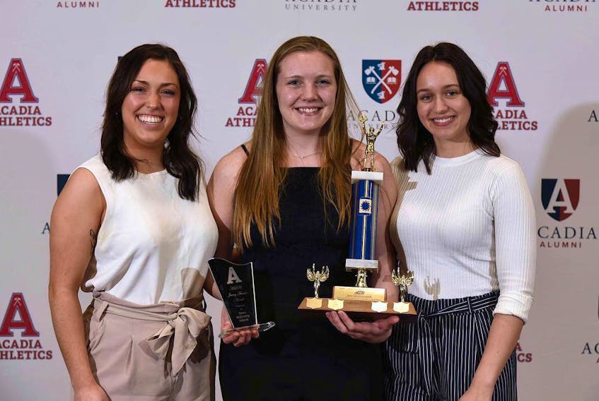 Tomi McCarthy (centre) is presented with the Acadia Students Union Jimmy Atomate award at the University's Department of Athletics annual Fred G. Kelly Awards Night on April 1 for her volunteer work and community involvement on and off campus. 
CONTRIBUTED