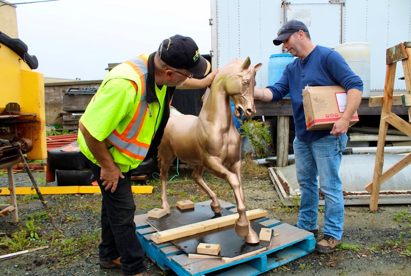 Stan Churchill, of All-Out Property Services, and Todd Muise, the Town of Yarmouth’s parks coordinator, inspect the Milton horse after it was returned to Yarmouth last week following repairs. The horse is part of a historic landmark fountain in the town that dates back to 1893.