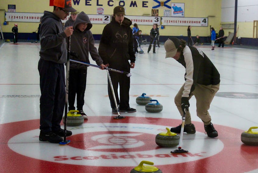 Yarmouth skip Ryan Richardson (right) sweeps during this past weekend’s under-15 men’s provincial bonspiel at the Yarmouth Curling Club. The Richardson team went 1-3 in the bonspiel. (Next to Richardson in this photo is Cohen Garron of Yarmouth, who played with a team from Liverpool during this past weekend’s event.)