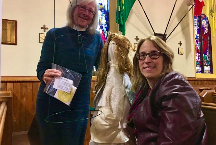 Angelfest committee members Rev. Helen Chandler and Rosemary Guyette hold samples of some of the craft ideas that people can adopt to participate in the upcoming Angelfest.