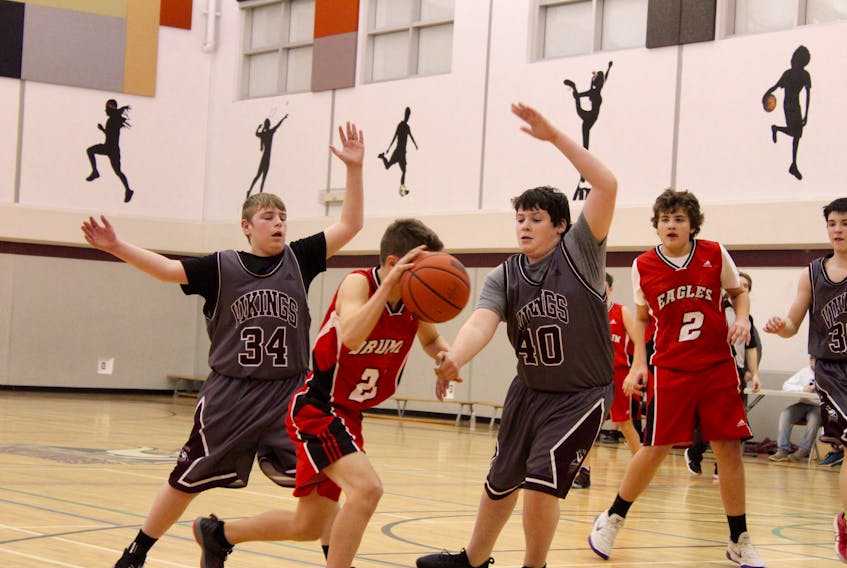 The YCMHS Grade 9 boys basketball team -- pictured here playing defence during a home game against Drumlin Heights in December -- were in action on the weekend of Jan. 12, winning two of three games in Bridgewater.