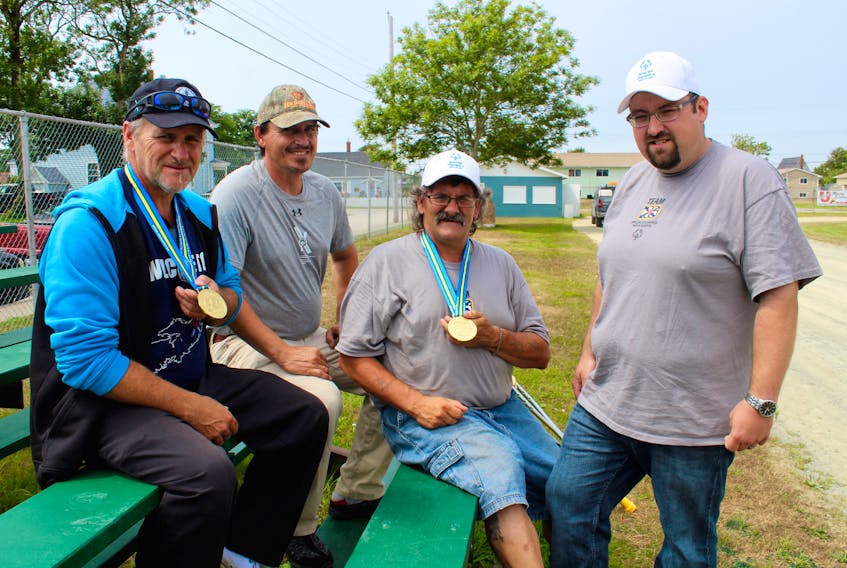 Members of the gold-medal-winning Nova Scotia Special Olympic softball team included (from left) Royce Murphy, Walter Muise and Tony Clairmont. Adam MacIsaac (far right) was one of the team’s assistant coaches.