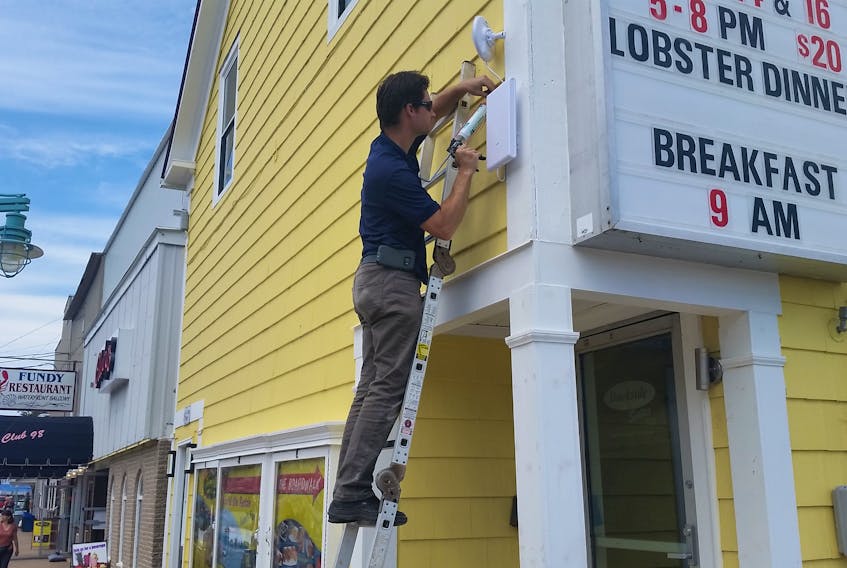 Brian Joudrey as he installed the public Wi-Fi equipment at various locations around Downtown Digby (photo submitted by Michael Carty).