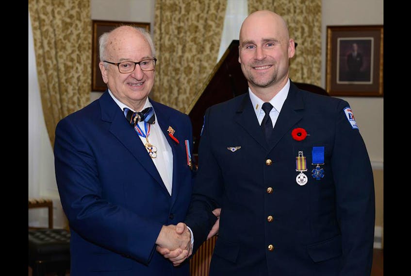 Lieutenant Governor Arthur J. LeBlanc presents Christopher Renaud with his Emergency Medical Services Exemplary Services medal.