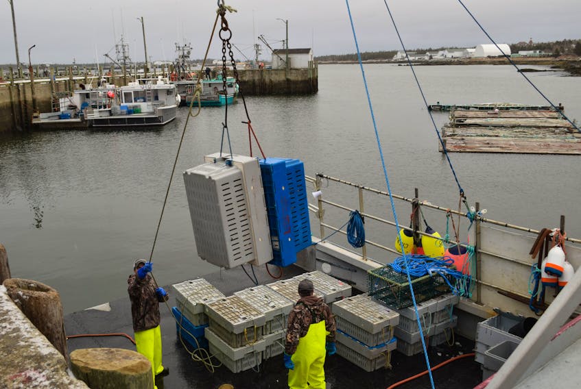 Crates of lobster are offloaded from a fishing vessel at the Lower Woods Harbour wharf. The $9 shore price set within two weeks of the season opening is still holding, although it has created resistance in the marketplace.