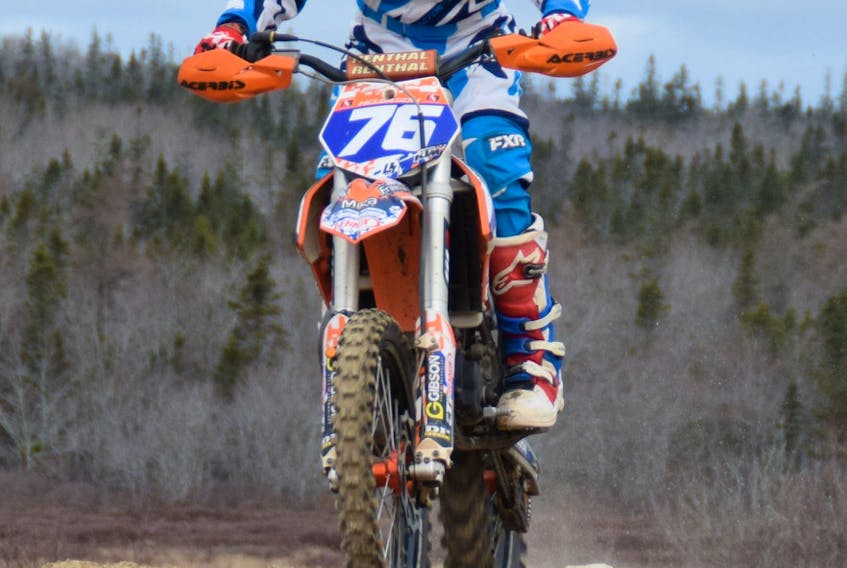 A young motocross rider comes in for a landing while doing laps at the Clyde River Motocross Track and Trails.