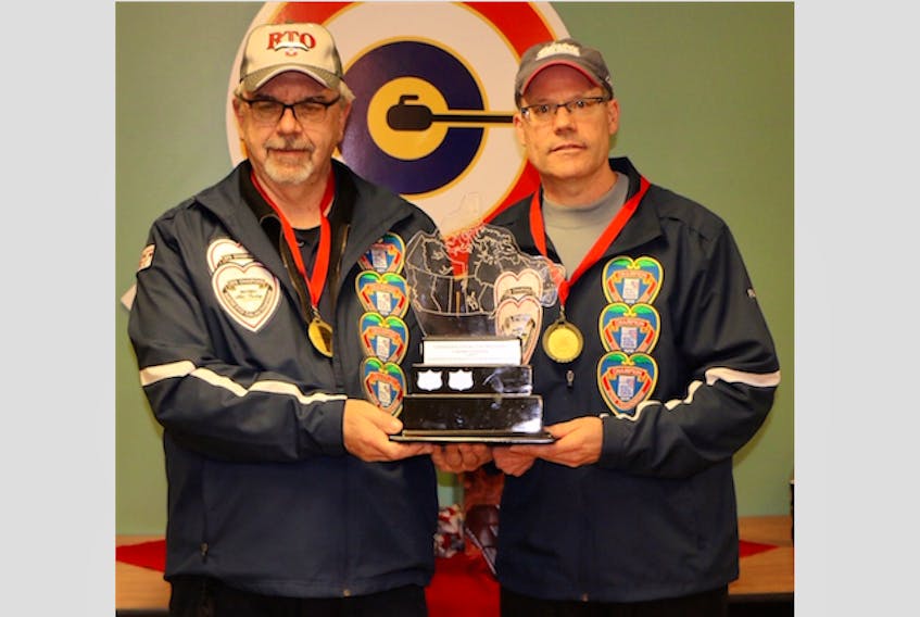 Dave MacDougal (left) and Paul Doucet, winners of the open division at the stick curling nationals in Cornwall, P.E.I.