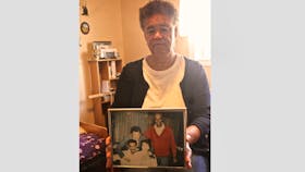 Louise Delisle of Shelburne, pictured in this file photo holding a family photo. AMY WOOLVETT