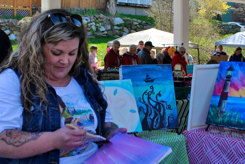 A vendor at the Guild Hall Farmer’s Market in Shelburne last summer works on a painting. The Town of Shelburne has secured a $12,500 grant from the Department of Canadian Heritage under the Canada Cultural Spaces Fund to help upgrade the popular outdoor space on the Shelburne waterfront.