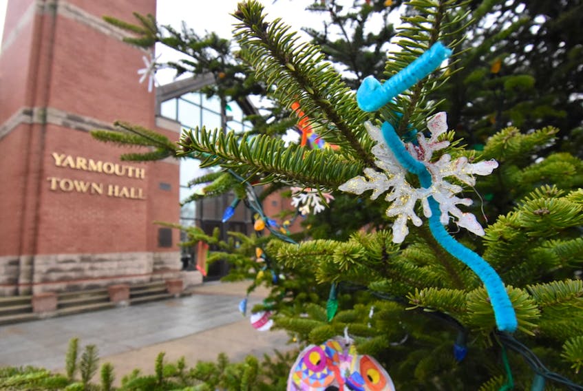 Decorations made by children adorn the Christmas tree outside the Yarmouth town hall. There is much grief and heartbreak in this town following the death of a four-year girl after she fell beneath a float during the annual Christmas parade. TINA COMEAU
