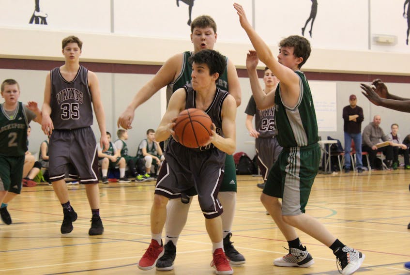 Owen Hemeon has the ball for Yarmouth during a Feb. 12 game against Lockeport. The Vikings were winners here and they were winners again a week later (Feb. 19), capturing the division 1 junior boys district title in Barrington, where they defeated the host Barons 74-56 in the championship game.