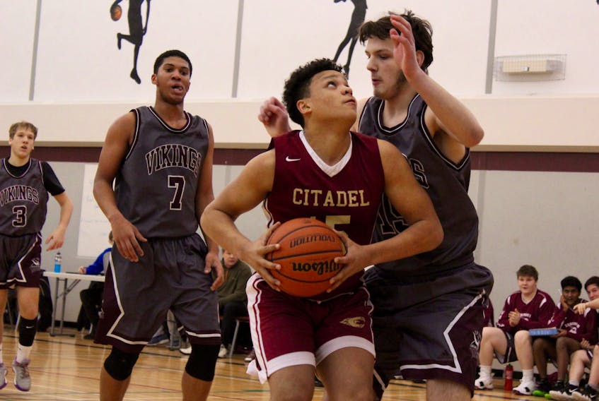 Cherokee Robinson has the ball for Citadel High School during Friday’s provincial qualifier in Yarmouth. At right is YCMHS player Josh Muise. Also pictured are Yarmouth players Mehmet Irtis (3) and Randal Fells (7). The Halifax team won the Feb. 22 game 86-58.