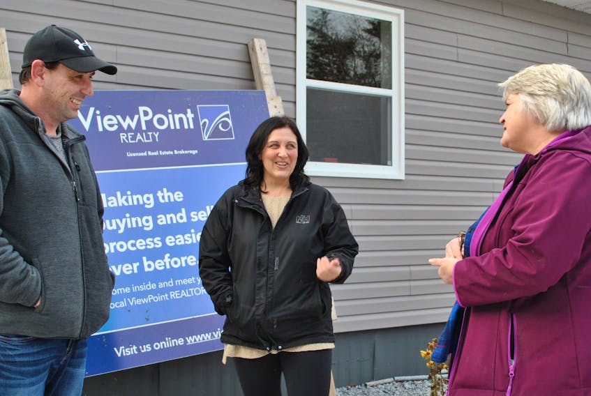 Real estate agents Jamie Reynolds (from left), Sandi Lee Stoddard and Bobbi Maxwell discuss next steps out side their temporary office in Barrington Passage. The three were displaced when fire destroyed a historic property in Barrington Passage.