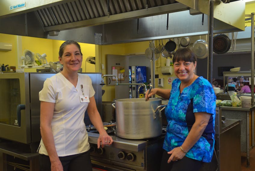 Two of Villa Acadienne’s cooks, Michelle Theriault and Louise Hill, stir up something savoury.