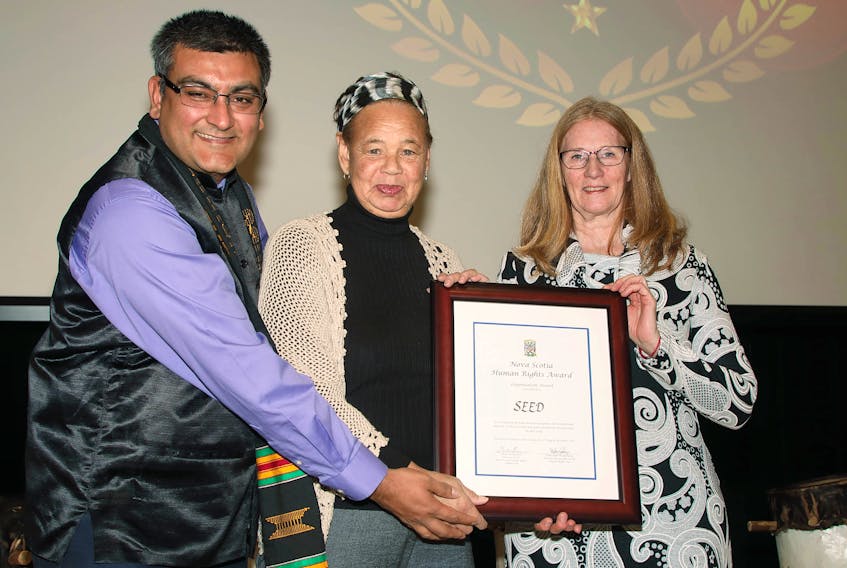 Louise Delisle, centre, and Mary Manning, right, from the South End Environmental Injustice Society are pictured with Vishal Bhardwaj, a commissioner with the Nova Scotia Human Rights Commission.