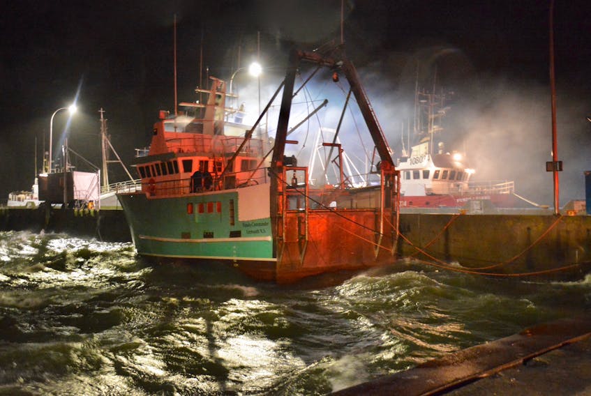 Firefighters were called to the Lobster Rock Wharf in Yarmouth the evening of Jan, 4 where the fishing vessel Fundy Commander was on fire. They were still on the scene the morning of Jan. 5. TINA COMEAU