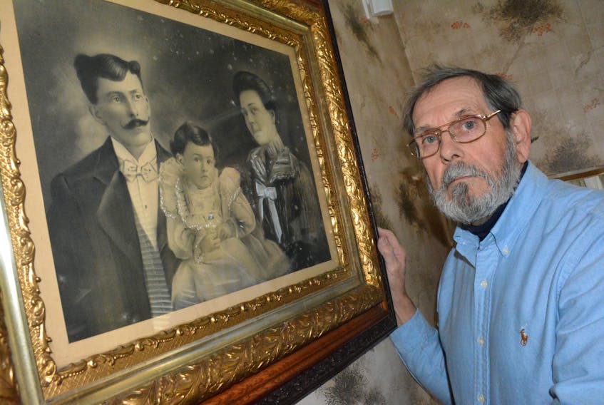 Yarmouth resident Don Parnell next to a family photograph of his great-grandfather Henry Doane, his grandfather Leslie when he was just a child, and his great-grandmother Etta. Henry Doane was among those to die in the Halifax Explosion 100 years ago.