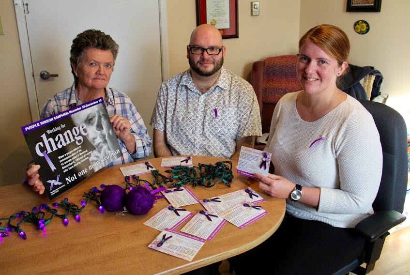Bernadette MacDonald of the Tri-County Women’s Centre, Adam Dolliver of SHYFT Youth Services and Lisa Newell-Bain of Juniper House with some of the items they hope will help raise awareness of abuse and violence against women. ERIC BOURQUE PHOTO