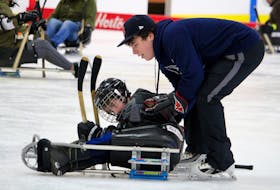People had a chance to try out sledge hockey during March Break at the Mariners Centre in Yarmouth. Instructor Miguel Surette offers a hand to one of the participants in a March 16 sledge hockey session at the Mariners Centre in Yarmouth. ERIC BOURQUE