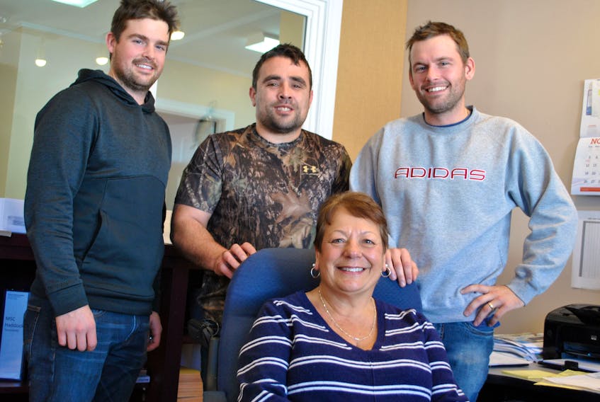 Nancy d’Entremont, long-time bookkeeper for Inshore Fisheries in West Pubnico, Yarmouth County, poses with the fourth generation of the family she has worked with during her career. From left: George, Andre and Marc d’Entremont. KATHY JOHNSON PHOTO