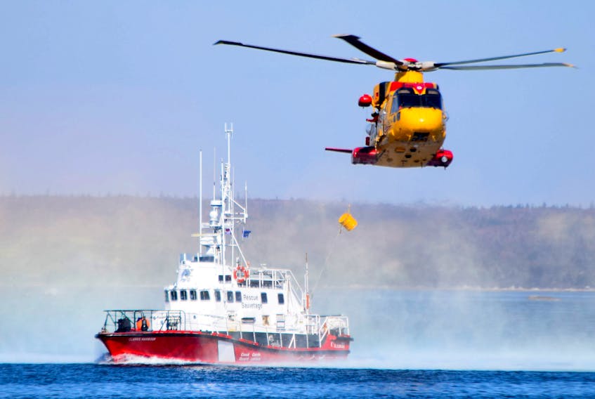 A Cormorant helicopter drops a pump to the Canadian Coast Guard cutter Clark’s Harbour during a search-and-rescue exercise off West Head, Cape Sable Island, last fall.  KATHY JOHNSON