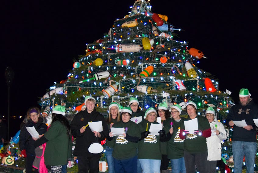 A choir gets ready to sing in front of the Lobster Pot Christmas Tree during the 2017 lighting festivities. KATHY JOHNSON