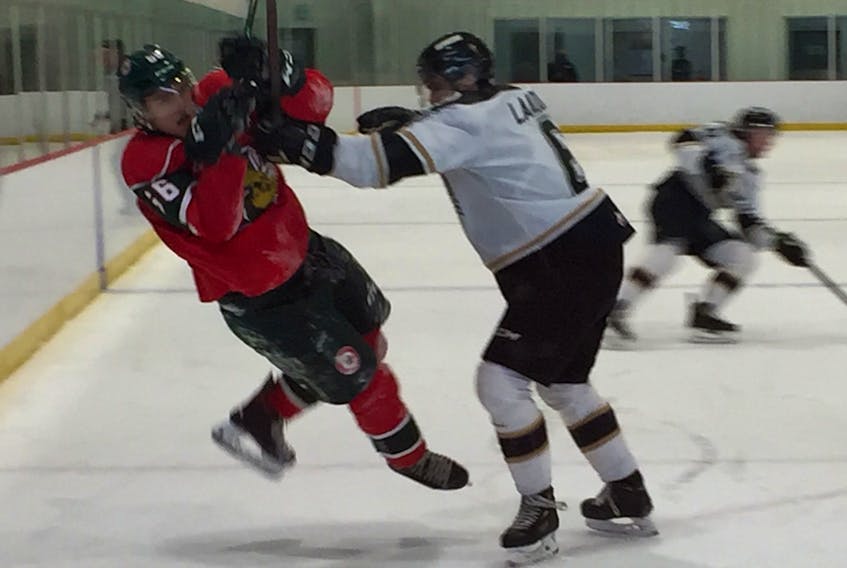 Charlottetown Islanders defenceman Noah Laaouan knocks over Halifax Mooseheads forward Zachary L'Heureux during Saturday's QMJHL exhibition game at the RBC Centre in Dartmouth. (WILLY PALOV/Chronicle Herald)