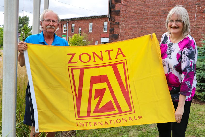 Amherst Mayor David Kogon and Zonta Club of Amherst Area director Lisa Emery raise the Zonta International flag on Sept. 11 to mark the beginning of Zonta Week in the Town of Amherst. Tom McCoag / Town of Amherst