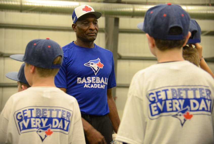 Lloyd Moseby talks with youngsters at the Honda Super Camps run by the Blue Jays Baseball Academy Thursday at Norton Diamond Soccer Complex in Stratford.