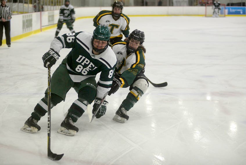 UPEI Panthers blue-liner Sydney Lyndon, left, tries to cut to the net on St. Thomas Tommies defenceman Alexandra Swift during Atlantic University Sport women's hockey action Saturday at MacLauchlan Arena.